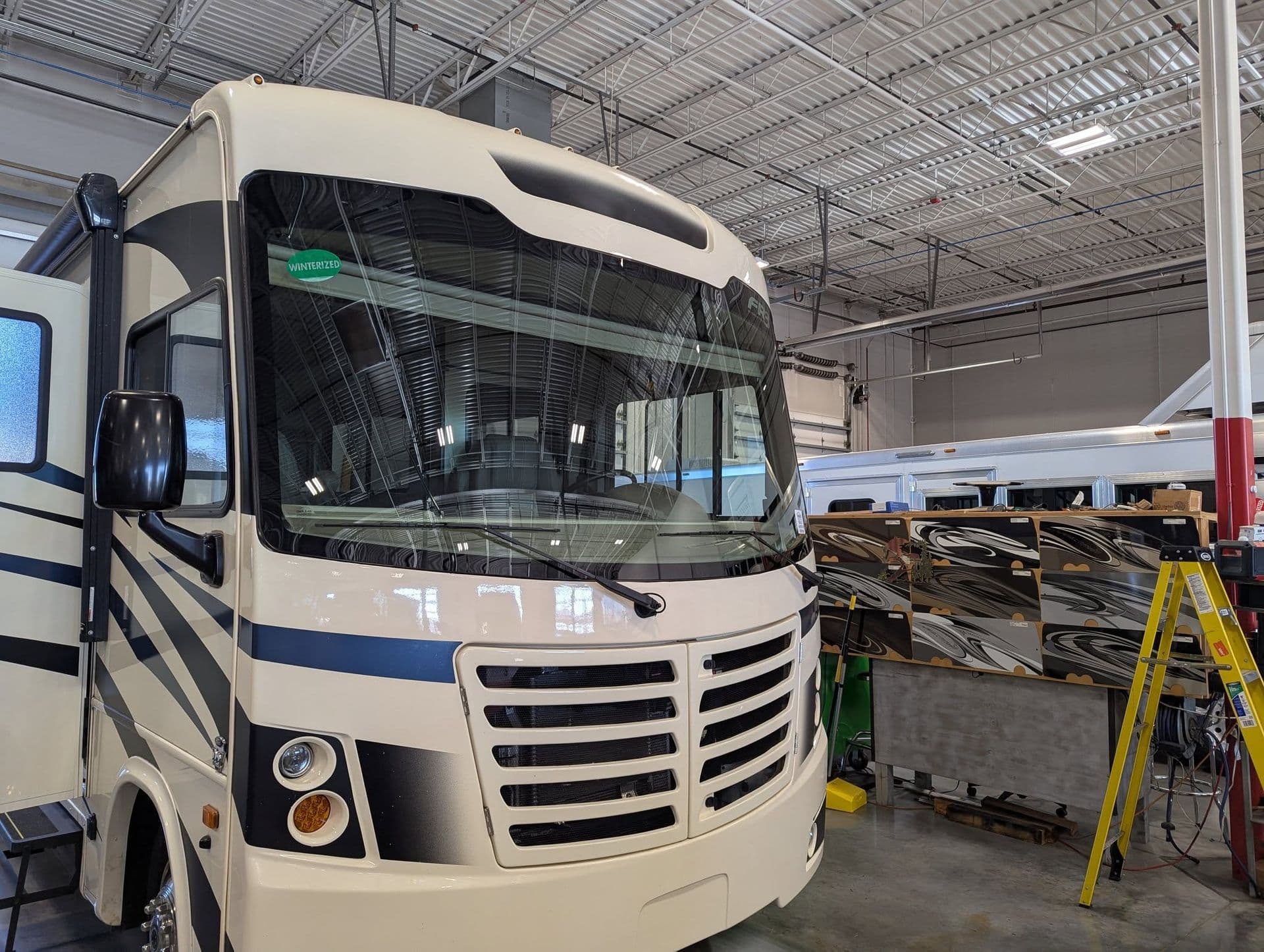 Class A motorhome with a large two piece windshield